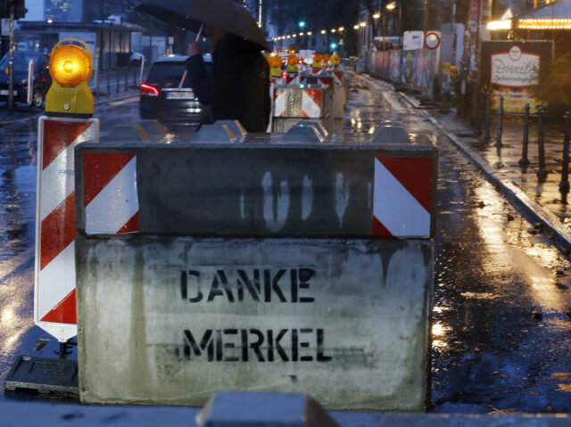 "Thanks Merkel" is written on one of the concrete barriers protecting the tradit