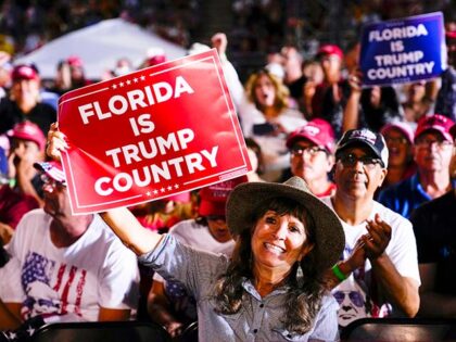 Attendees show their support for former President Donald Trump during a campaign rally in