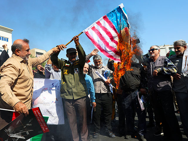 Iranian worshippers burn a representation of the U.S. flag during an anti-Israeli rally af