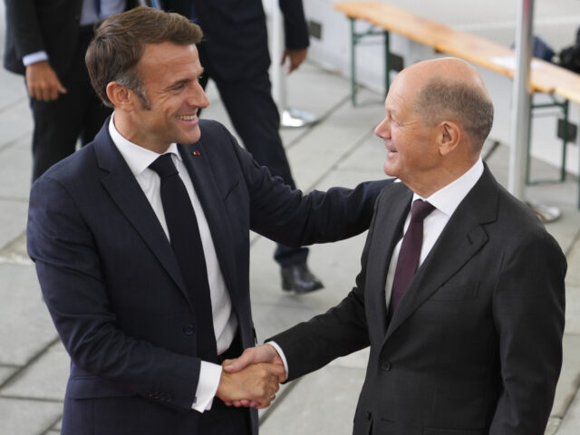 German Chancellor Olaf Scholz, right, welcomes French President Emmanuel Macron for a meet