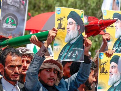 Houthi supporters raise pictures of slain Hezbollah leader Hassan Nasrallah, during an ant