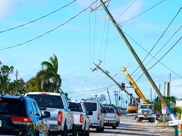 Cars move slowly after Hurricane Milton damaged power lines, Thursday, Oct. 10, 2024, in M