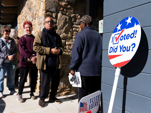 People wait in line at a polling place during the first day of early in-person voting in A