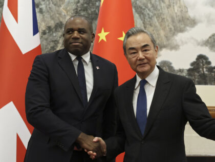 Britain's Foreign Secretary David Lammy and Chinese Foreign Minister Wang Yi shake ha