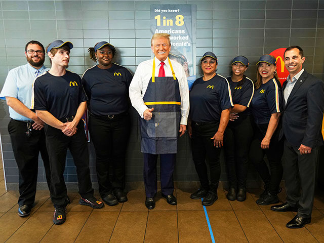 Republican presidential nominee former President Donald Trump poses with employees during