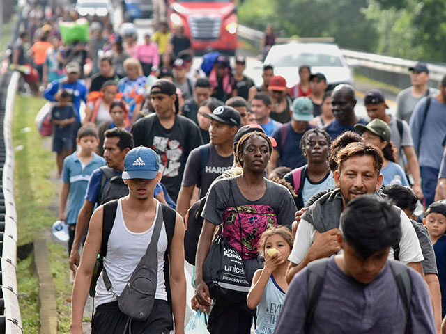 Migrants walk along the Huixtla highway in the state of Chiapas, Mexico, Tuesday, Oct. 22,