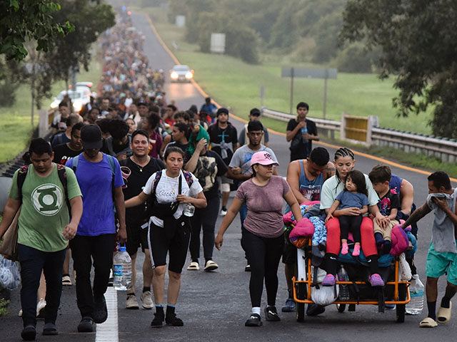 Migrants walk along the Huixtla highway in the state of Chiapas, Mexico, Tuesday, Oct. 22,