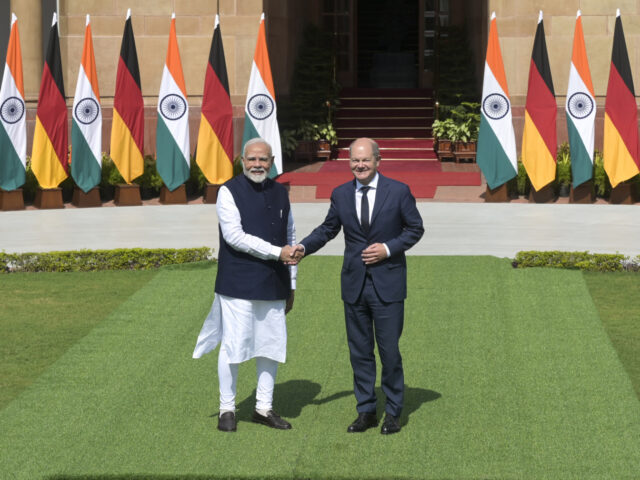 Indian Prime Minister Narendra Modi, left, and German Chancellor Olaf Scholz shake hands a