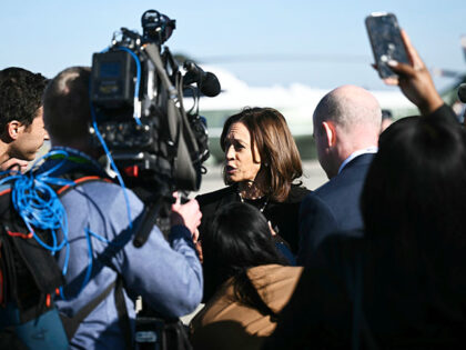 Democratic presidential nominee Vice President Kamala Harris talks to reporters before boa