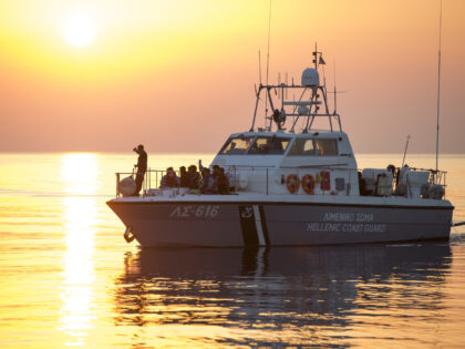 A coastguard boat with a group of migrants and refugees arrives at the port in the southea