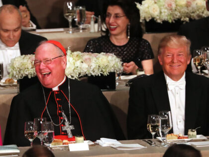 Cardinal Timothy Dolan sits between, Hillary Clinton and Donald Trump attend the annual Al