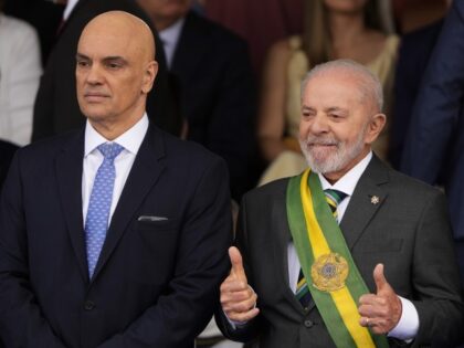 Brazilian President Luiz Inacio Lula da Silva flashes two thumbs up alongside Supreme Cour