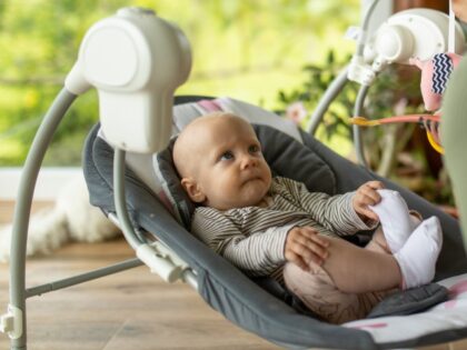 Baby in baby swing