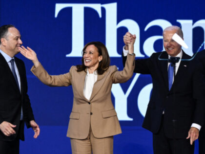 US President Joe Biden (R) raises hands with US Vice President and 2024 Democratic preside