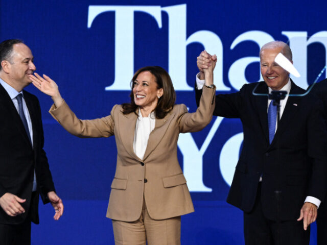 US President Joe Biden (R) raises hands with US Vice President and 2024 Democratic preside