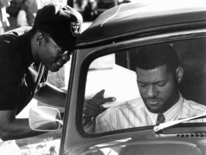 A man approaches Laurence Fishburne in a scene from the film 'Boyz N The Hood',