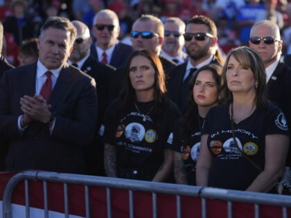 Family members of Corey Comperatore, including his wife Helen, second from right, stand wi