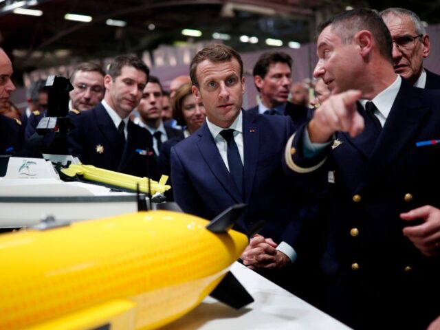 French President Emmanuel Macron (C) listens to explanations as he visits a stand at Euron