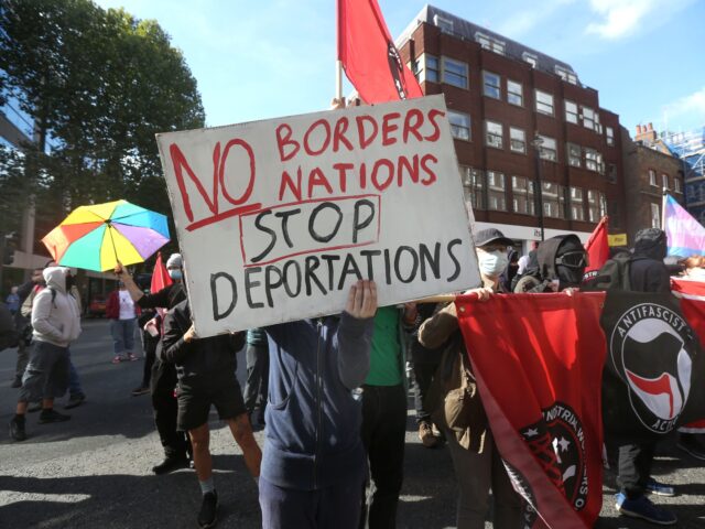 LONDON, ENGLAND - SEPTEMBER 24: A counter demonstration forms near the Home Office with a