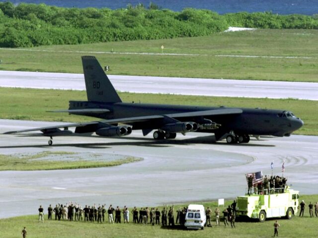 US Air Force ground crew members wave at a B-52H Stratofortress bomber as it taxis in Dieg