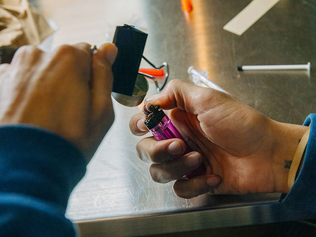 Will Martin prepares an injection of fentanyl inside the overdose prevention center at OnP