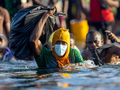 Haitian immigrants cross the Rio Grande back into Mexico from Del Rio, Texas on September