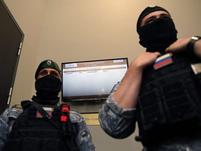 Law enforcement officers stand guard in a Moscow courtroom on September 26, 2023 during th