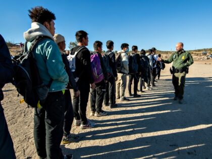 Border patrol agents process migrants who entered the US illegally the day before before t