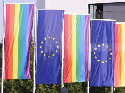 27 June 2024, North Rhine-Westphalia, Essen: Rainbow flags and flags of the European Union