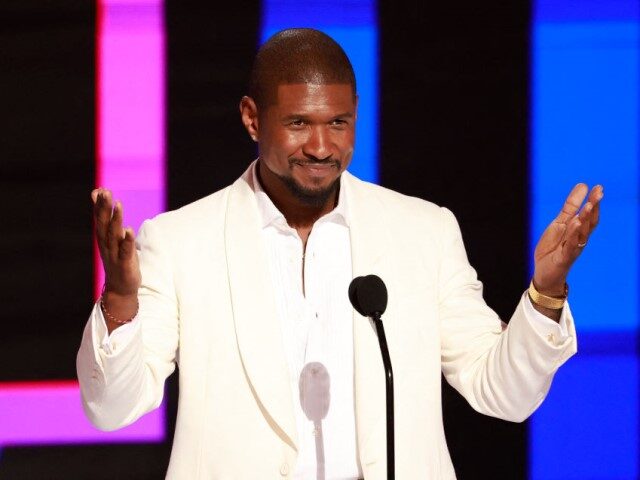 US singer-songwriter Usher speaks on stage after accepting the Lifetime Achievment award d