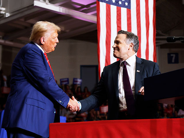 Republican presidential nominee, former U.S. President Donald Trump (L) shakes hands with