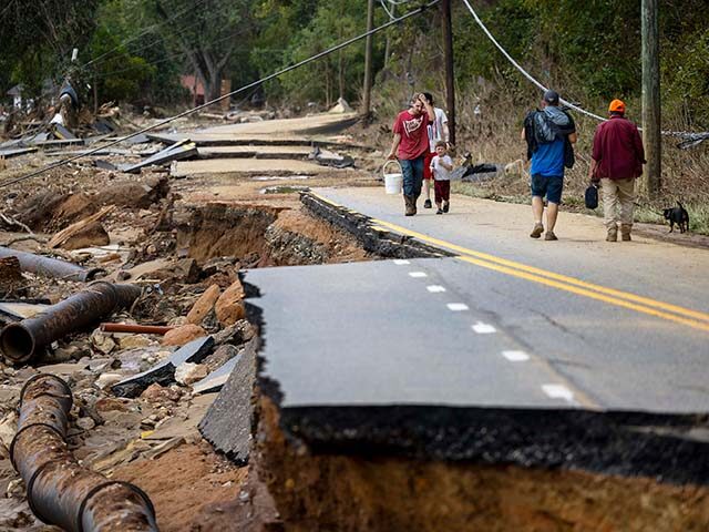 Swannanoa residents walk through devastating flood damage from the Swannanoa River on Sund