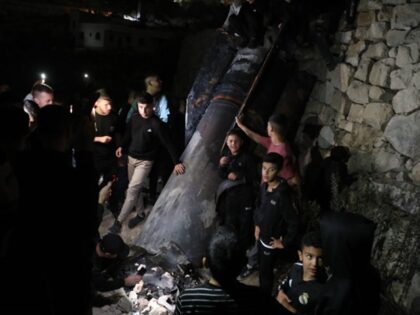 HEBRON, WEST BANK - OCTOBER 1: Palestinians inspect debris of a missile fired from Iran to