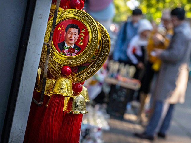 Charms showing Chinas President Xi Jinping are seen for sale outside a shop during the Nat