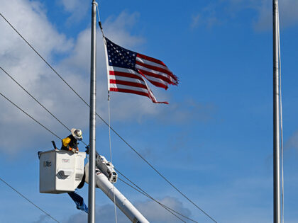 A lineman repairs electric lines in the aftermath of Hurricane Milton, in Siesta Key, Flor