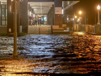 FORT MYERS BEACH, FLORIDA - OCTOBER 09: People look out at surge waters flooding the stree