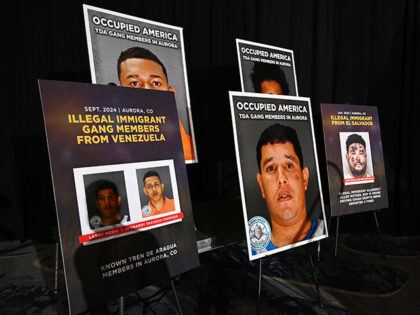 Signs with pictures of Venezuelan gang members were on stage for former President Donald J