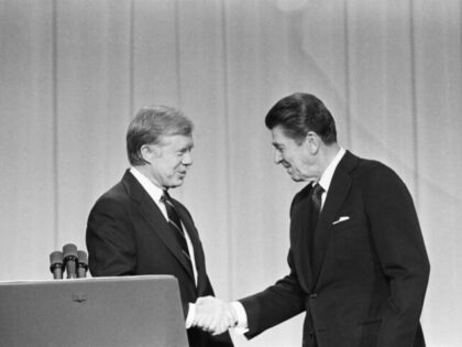 President Jimmy Carter and his Republican challenger, Ronald Reagan, shake hands as they g