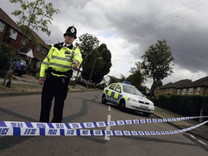 HIGH WYCOMBE, ENGLAND - AUGUST 10: A police officer stands guard outside of Walton Drive a