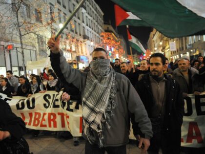 People demonstrate against the Israeli over air attacks on the Gaza Strip which have kille