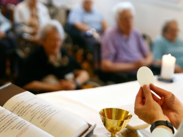 Retirment home. Sunday catholic mass in the chapel. Eucharist celebration.