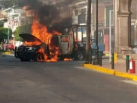 Police vehicle in flames after a cartel attack with car bombs in Guanajuato. (Credit: Brei