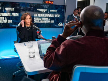 Democratic presidential nominee, Vice President Kamala Harris (L) prepares to speak with C