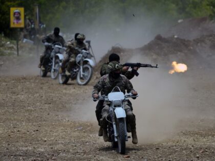 Fighters from the Lebanese militant group Hezbollah carry out a training exercise in Aaram