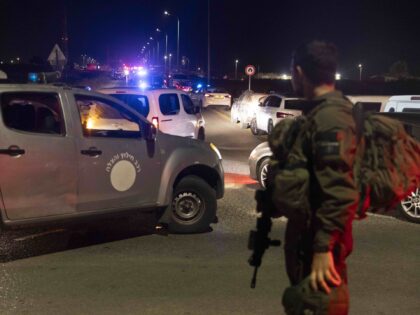 BINYAMINA, ISRAEL - OCTOBER 13: An Israeli soldier secures a road after a drone attack tha