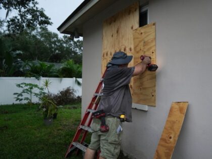 A resident boards up his windows in Palm Harbor, Florida, ahead of Hurricane Milton's