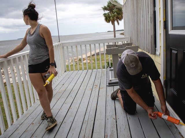 Mike Williams seals a rental cottage at Cedar Key, FL, on Wednesday, September 25, 2024, i