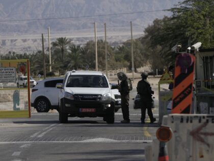 Israeli soldiers check a vehicle at the entrance of Moshav Ein Tamar near the site where I