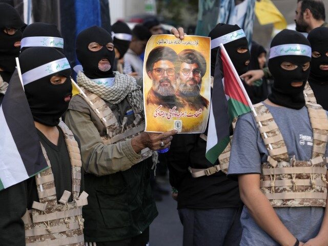 A group of the Iranian demonstrators cover their faces in the Palestinian and Lebanese mil