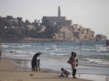 Israeli Arabs enjoy the Mediterranean Sea during the Muslim Eid al-Fitr holiday, that mark